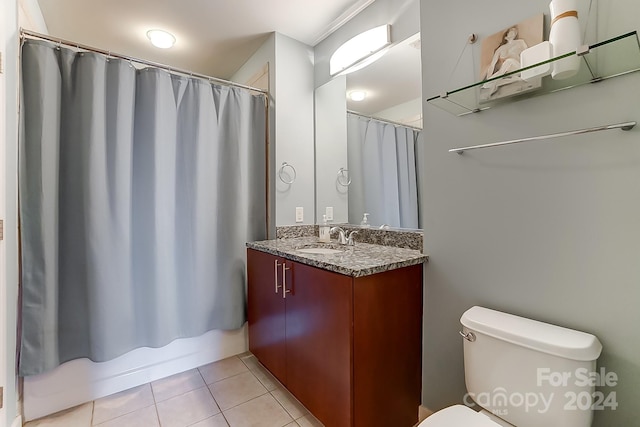 full bathroom with toilet, shower / tub combo, vanity, and tile patterned flooring