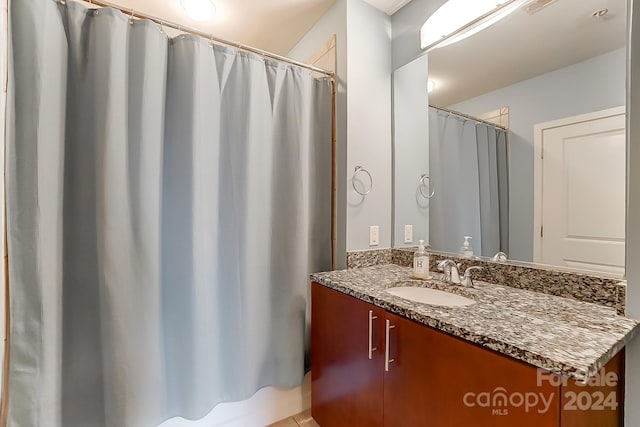 bathroom featuring vanity and shower / bath combination with curtain