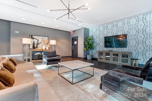 living room featuring wood-type flooring and an inviting chandelier