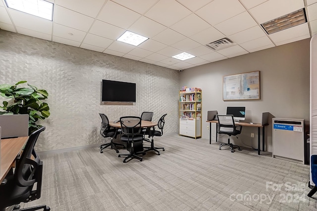 office area with a paneled ceiling and light carpet