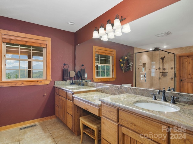 bathroom featuring vanity, a shower with shower door, and tile patterned flooring