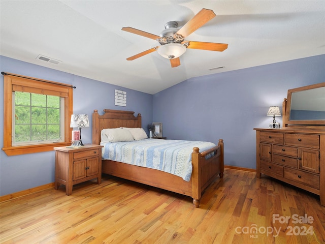 bedroom featuring ceiling fan, light wood-type flooring, and vaulted ceiling