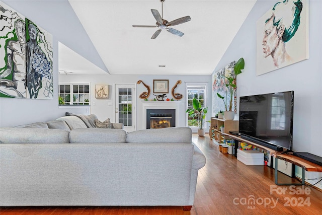 living room with ceiling fan, hardwood / wood-style floors, and lofted ceiling