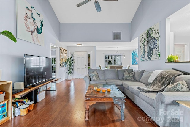 living room featuring ceiling fan, high vaulted ceiling, and wood-type flooring