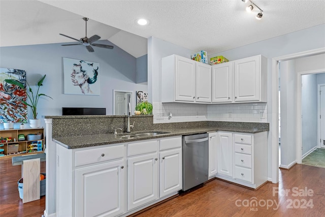 kitchen with dishwasher, sink, dark hardwood / wood-style flooring, lofted ceiling, and white cabinets