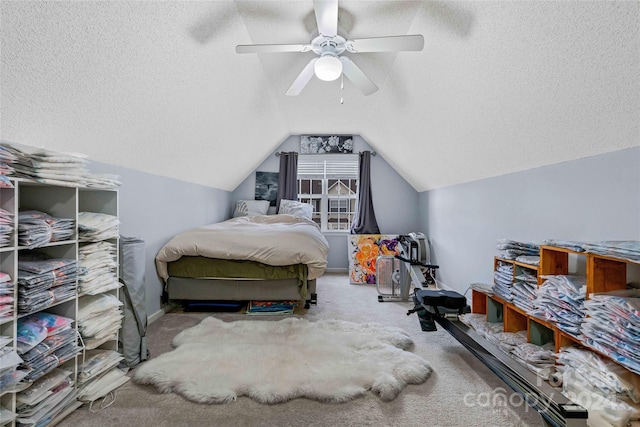 bedroom featuring a textured ceiling, ceiling fan, lofted ceiling, and carpet floors