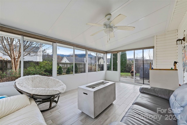 sunroom featuring a wealth of natural light, ceiling fan, and vaulted ceiling