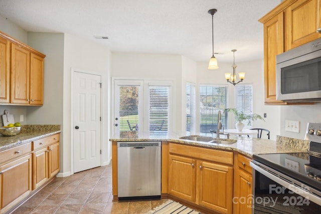 kitchen with appliances with stainless steel finishes, light stone countertops, hanging light fixtures, an inviting chandelier, and sink