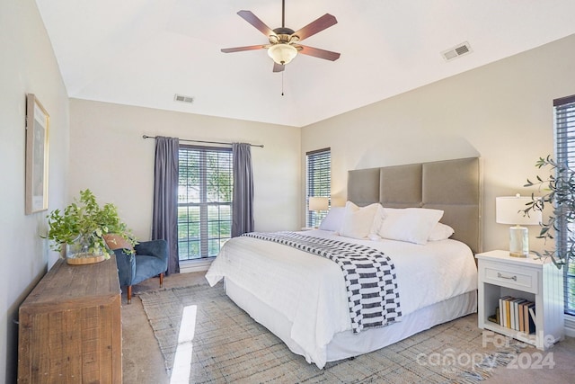 bedroom with lofted ceiling, ceiling fan, and carpet floors