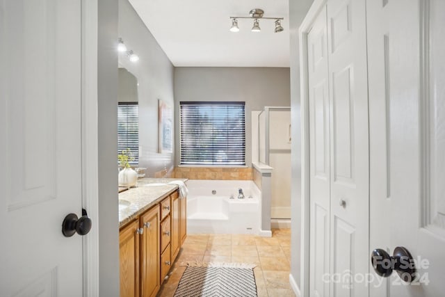 bathroom with independent shower and bath, vanity, and tile patterned floors