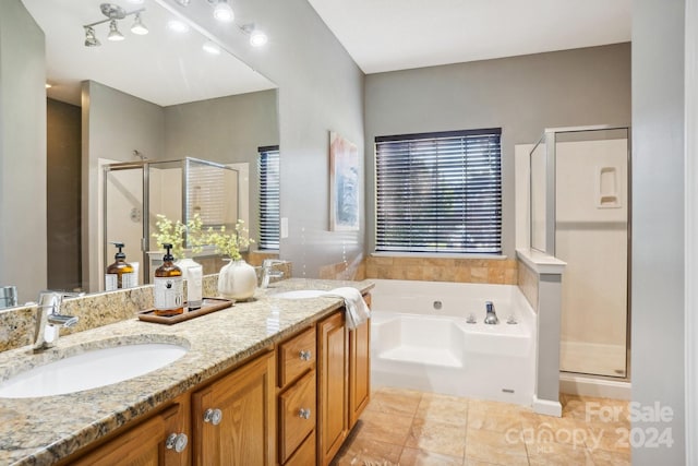 bathroom with independent shower and bath, vanity, and tile patterned floors