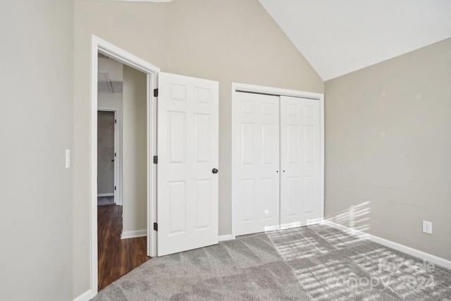 unfurnished bedroom featuring carpet, high vaulted ceiling, and a closet