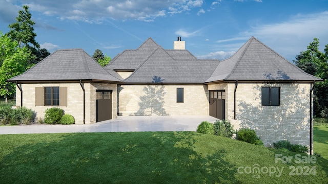 french country style house with a patio and a front yard