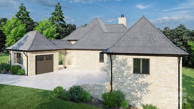 exterior space featuring a patio, a garage, and a yard