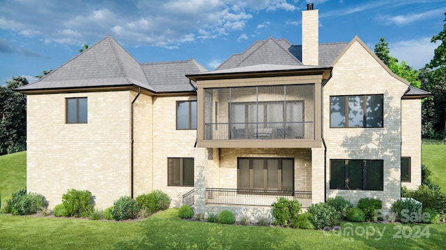 rear view of house with a balcony and a yard