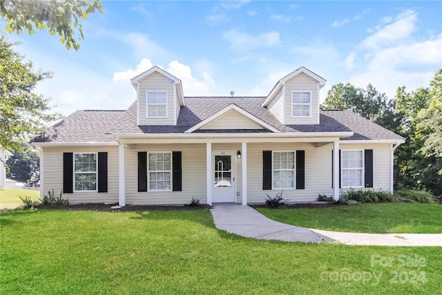 cape cod house featuring a front yard and covered porch