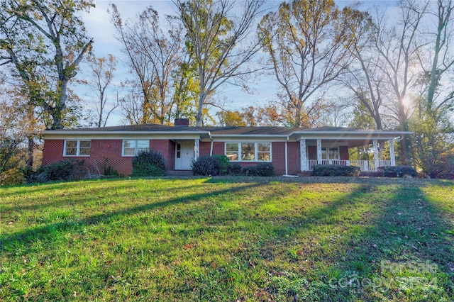 single story home with a front lawn and a porch