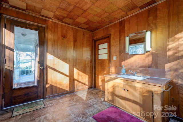 entryway with wood walls, sink, and wooden ceiling