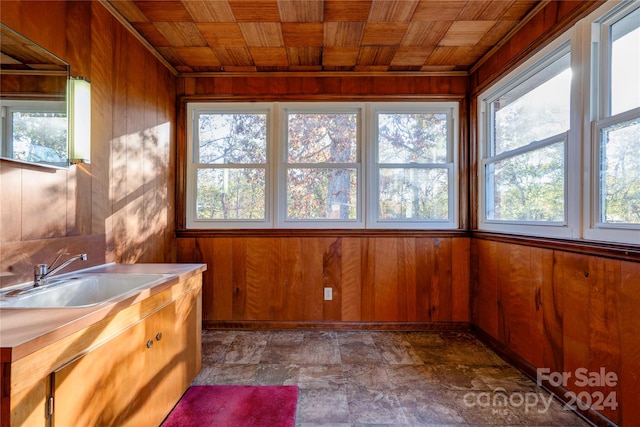 unfurnished sunroom featuring a wealth of natural light, sink, and wood ceiling