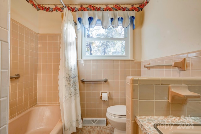 full bathroom featuring shower / tub combo, tile patterned flooring, toilet, vanity, and tile walls