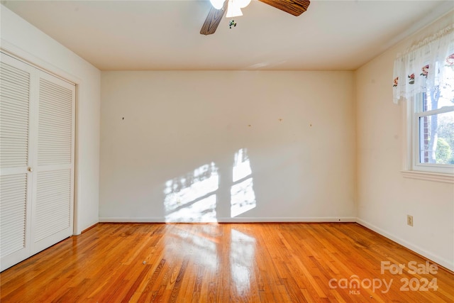 unfurnished bedroom featuring a closet, ceiling fan, and light wood-type flooring