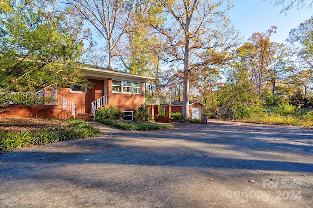 view of front of home with an outdoor structure and a garage