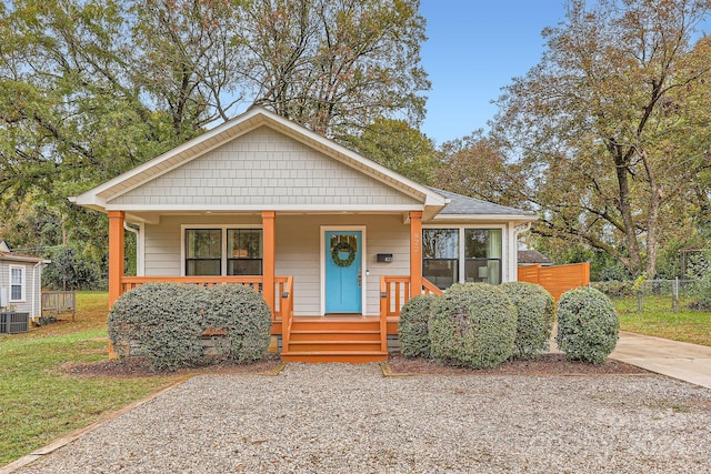 bungalow-style home with central AC unit and a porch