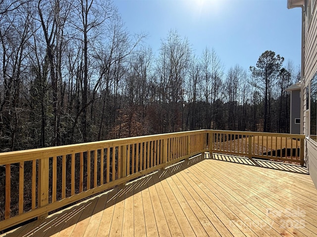 wooden deck featuring a wooded view