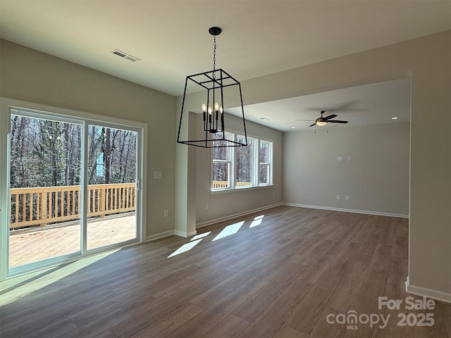 unfurnished dining area featuring ceiling fan, wood finished floors, visible vents, and baseboards