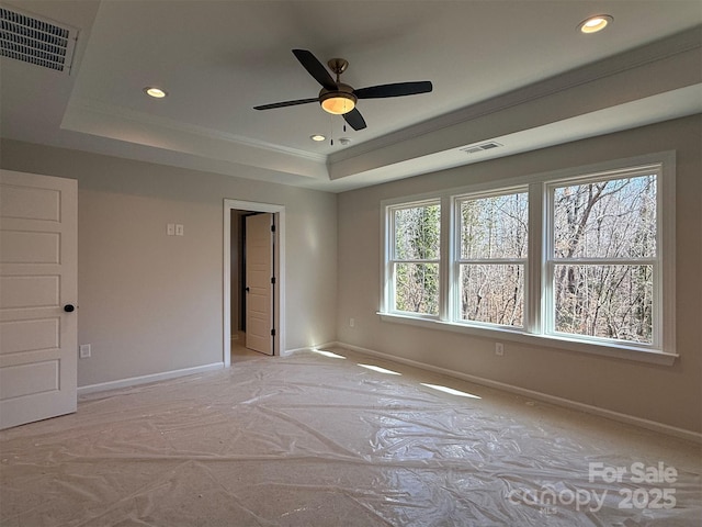 unfurnished bedroom with baseboards, visible vents, a raised ceiling, and recessed lighting