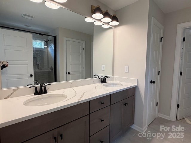 full bath with double vanity, a stall shower, visible vents, and a sink