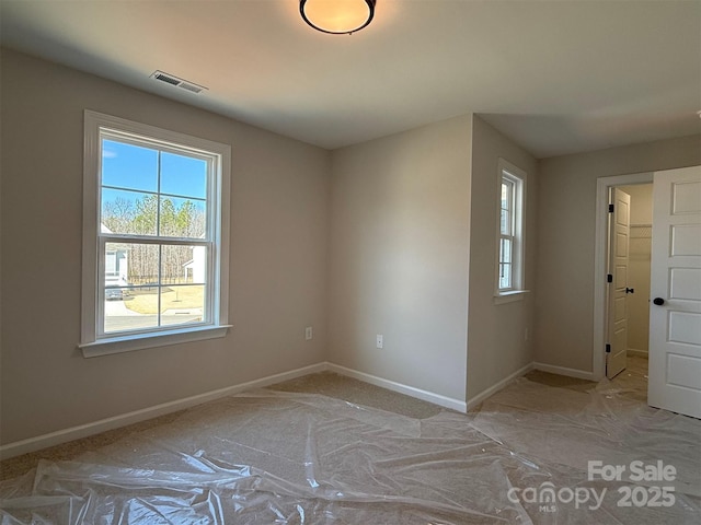 spare room with visible vents and baseboards