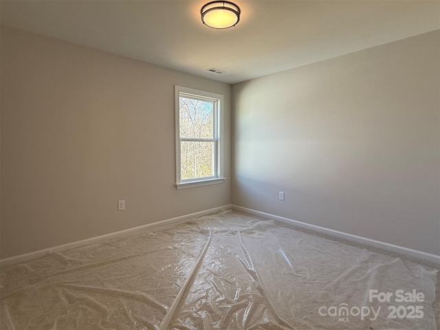 spare room featuring visible vents and baseboards