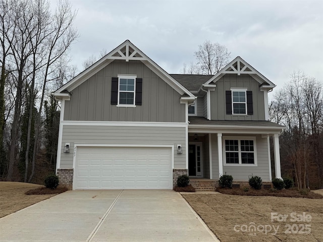 craftsman-style home with an attached garage, a porch, board and batten siding, and concrete driveway