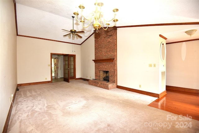 unfurnished living room with high vaulted ceiling, crown molding, hardwood / wood-style floors, a fireplace, and ceiling fan with notable chandelier