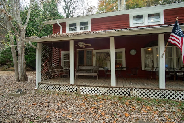 back of house with ceiling fan and a wooden deck