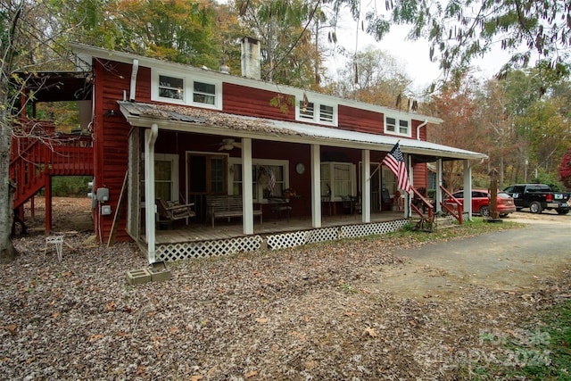 rear view of house featuring a porch