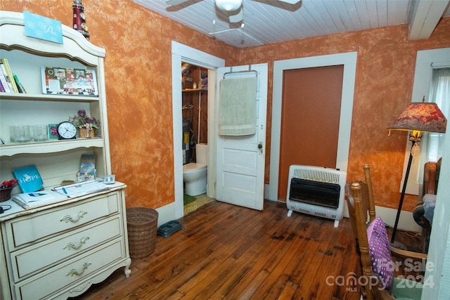 bedroom featuring heating unit, dark wood-type flooring, wooden ceiling, ceiling fan, and ensuite bathroom