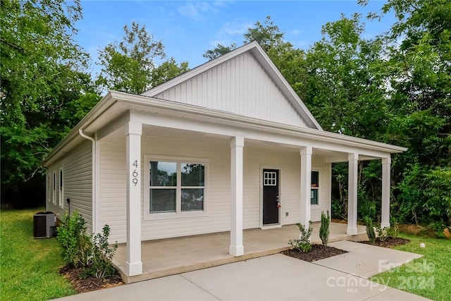 view of front of house featuring a porch and cooling unit