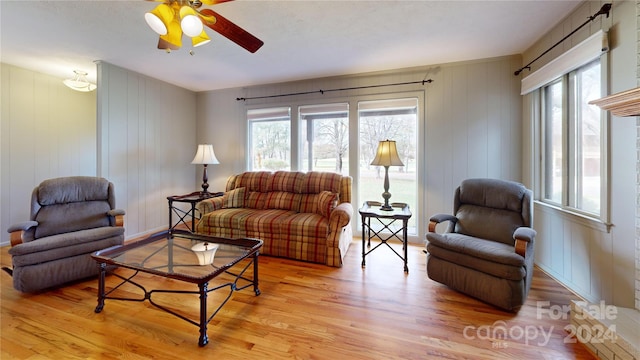 living room featuring ceiling fan and light hardwood / wood-style flooring