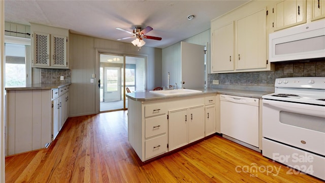 kitchen featuring kitchen peninsula, tasteful backsplash, ceiling fan, white appliances, and light wood-type flooring