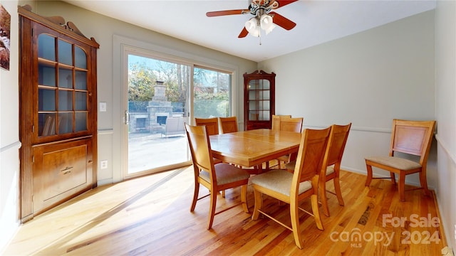 dining space with light wood-type flooring and ceiling fan