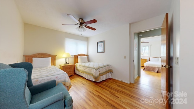 bedroom with ceiling fan and light wood-type flooring