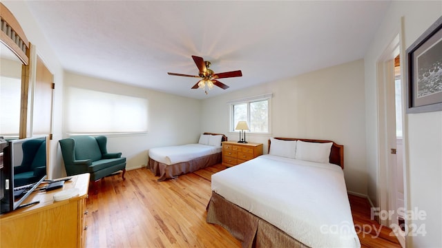 bedroom with wood-type flooring and ceiling fan