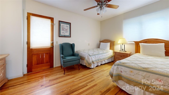 bedroom with light hardwood / wood-style floors and ceiling fan