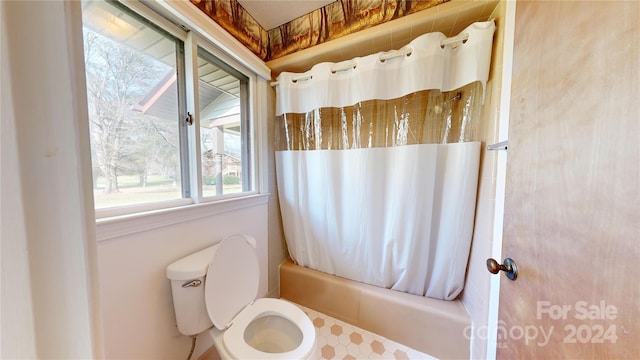 bathroom with toilet and shower / tub combo