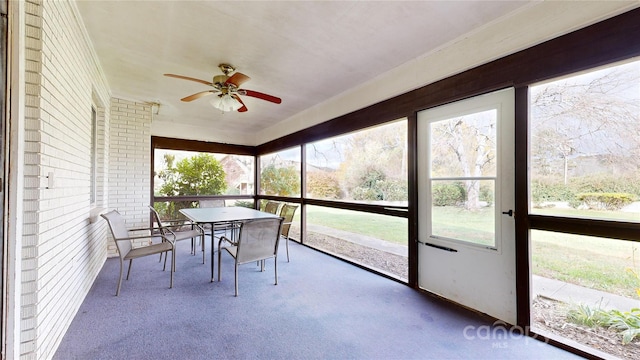 sunroom / solarium featuring ceiling fan