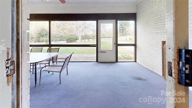 sunroom / solarium with ceiling fan