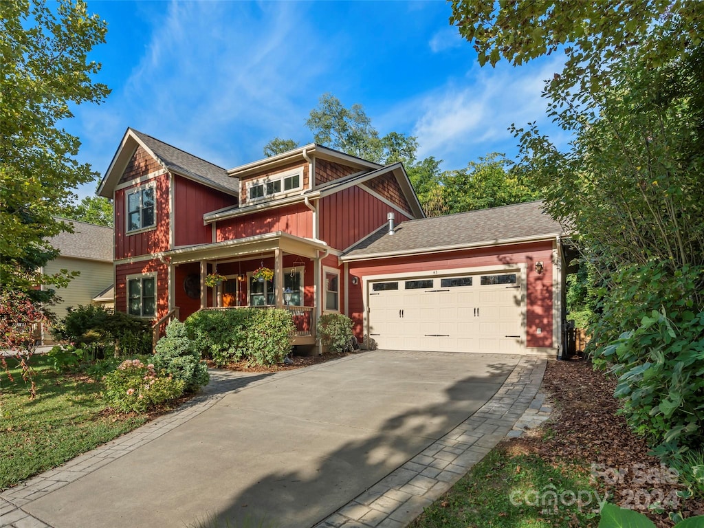 craftsman inspired home featuring a garage and a porch