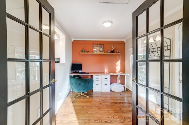 office featuring crown molding and light hardwood / wood-style flooring